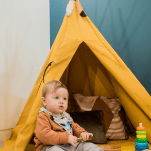Baby and a yellow kid's tent