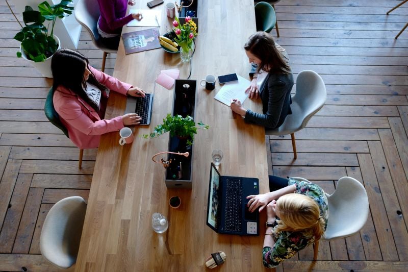 Three people working in a coworking space