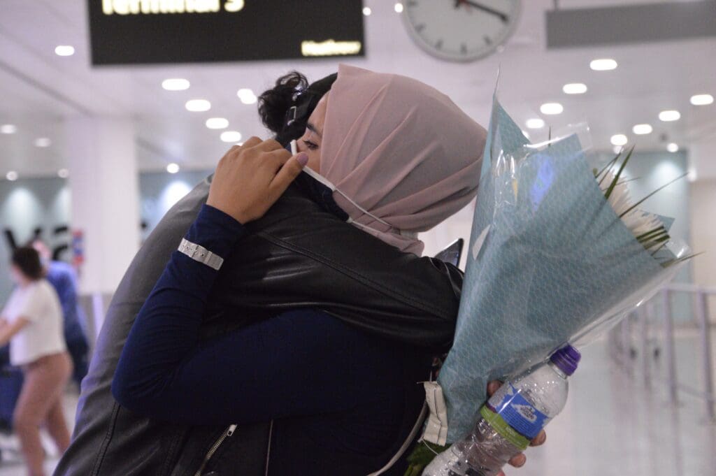 People hugging at the airport