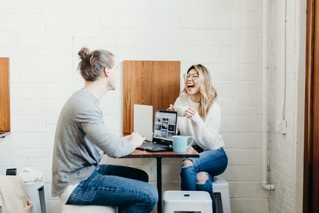 People having a business meeting and laughing.