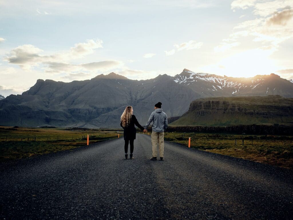 Couple holding hands on the Ring Road, Iceland