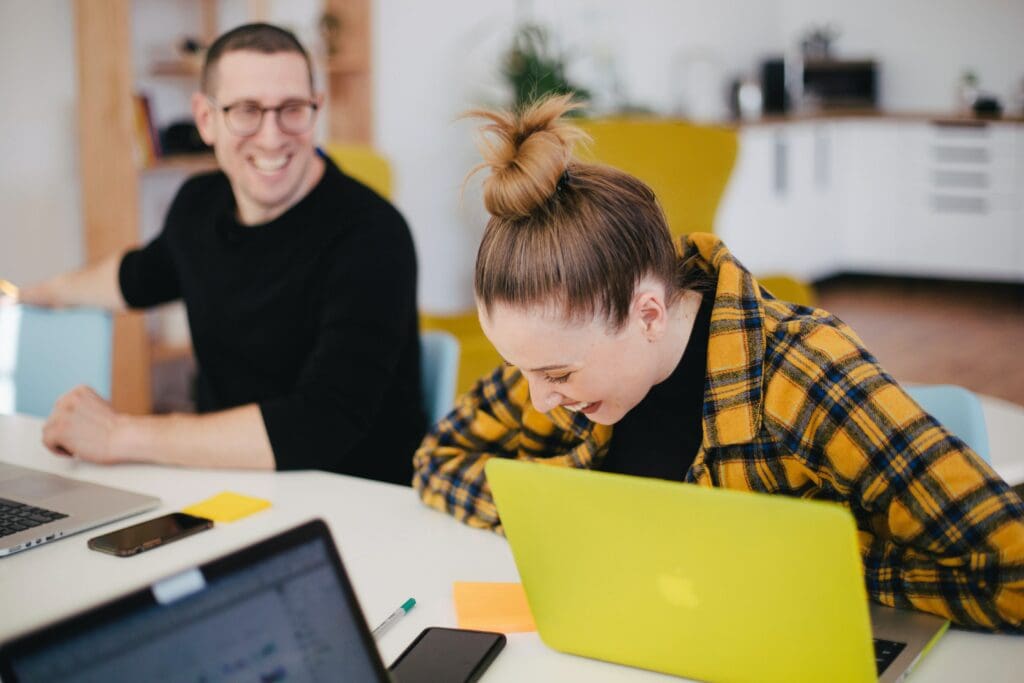 People having a laugh whilst meeting in person for a business meeting