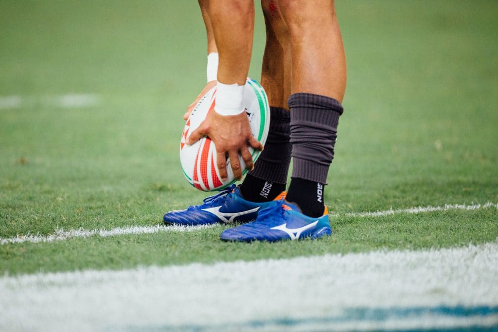 Person holding a rugby ball