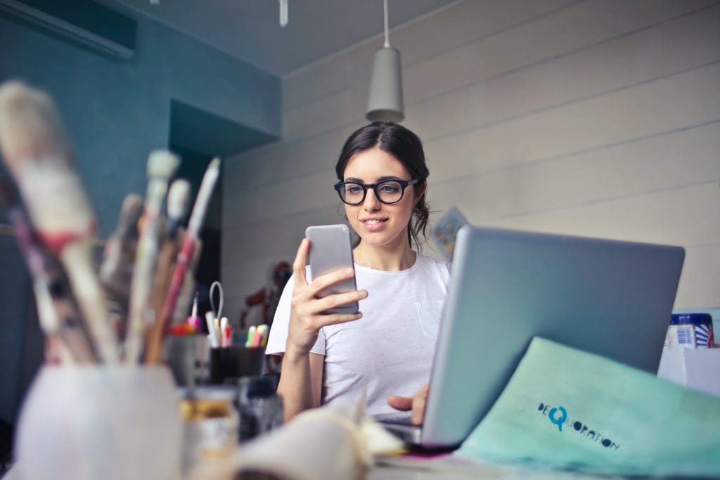 Girl looking at her phone - business in Houston