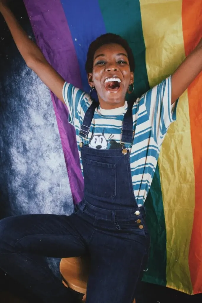 A person carries a rainbow flag