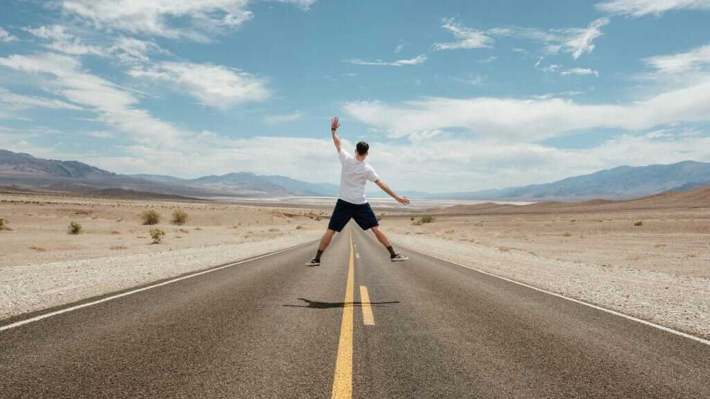 person jumping on a road