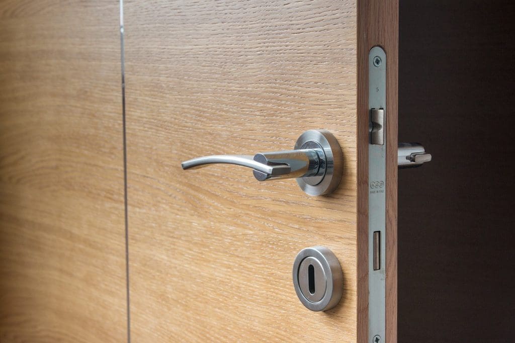 a brown wooden door with brushed steel handle and lock