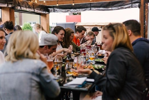 People eating around a table in a restaurant