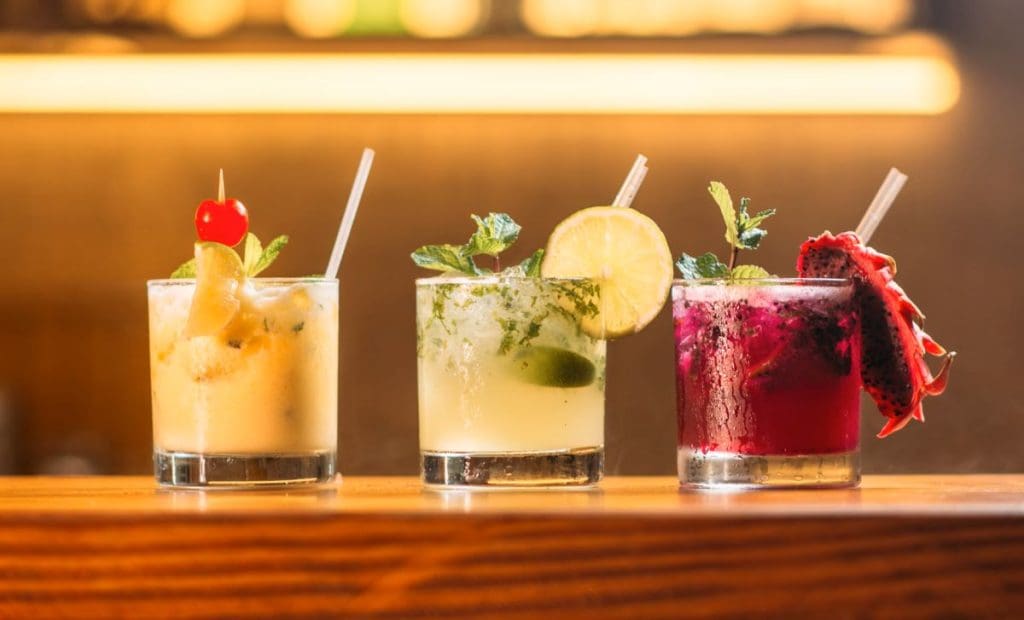 Three cocktails on a wooden table