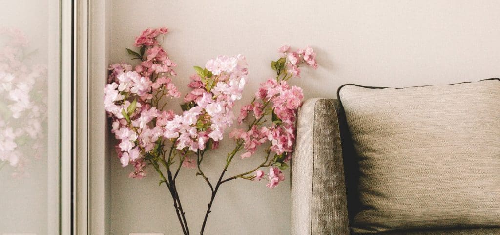 flowers next to a sofa