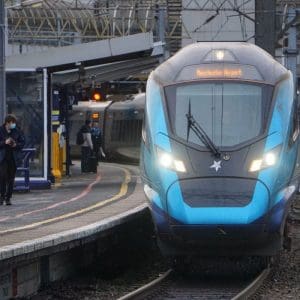 A train arriving at a platform at Manchester Piccadilly train station.