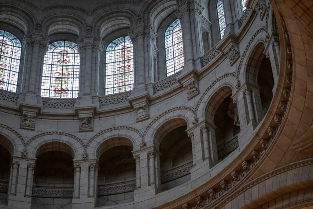 Inside Sacré-Cœur Basilica in Paris, showing large columns and windows