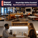 Two people sat at a table having a conversation and the communal area of Staybridge Suites Vauxhall
