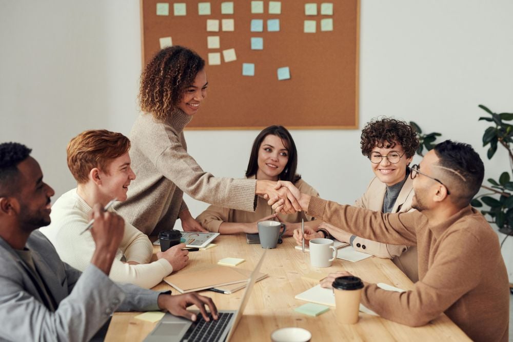 People shaking hands during a meeting